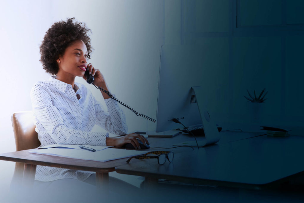 Woman on phone call at a desk representing webex calling